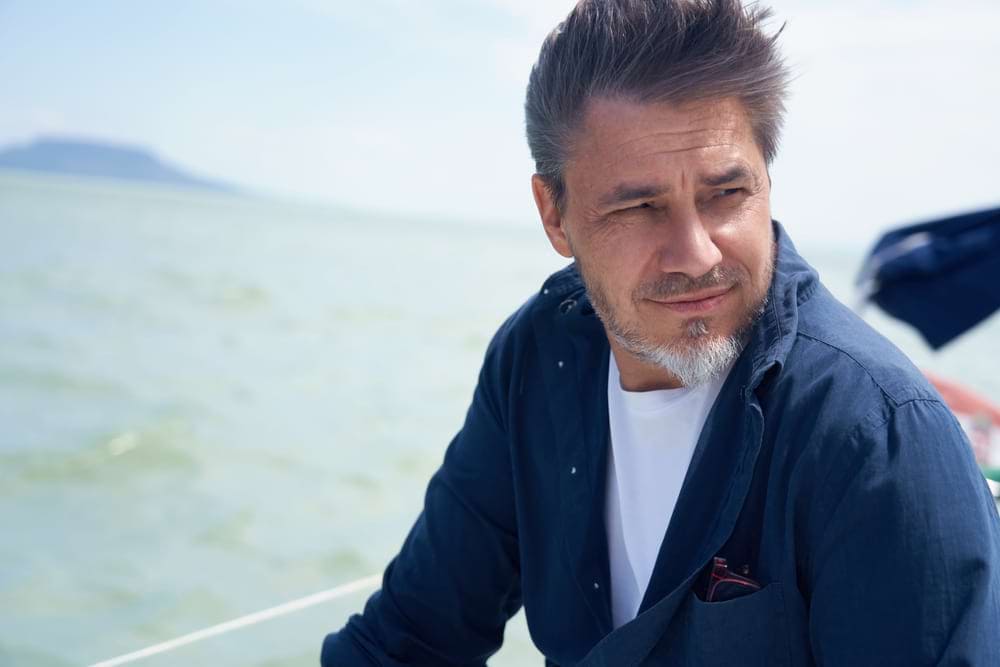 man watches sea burial of loved one